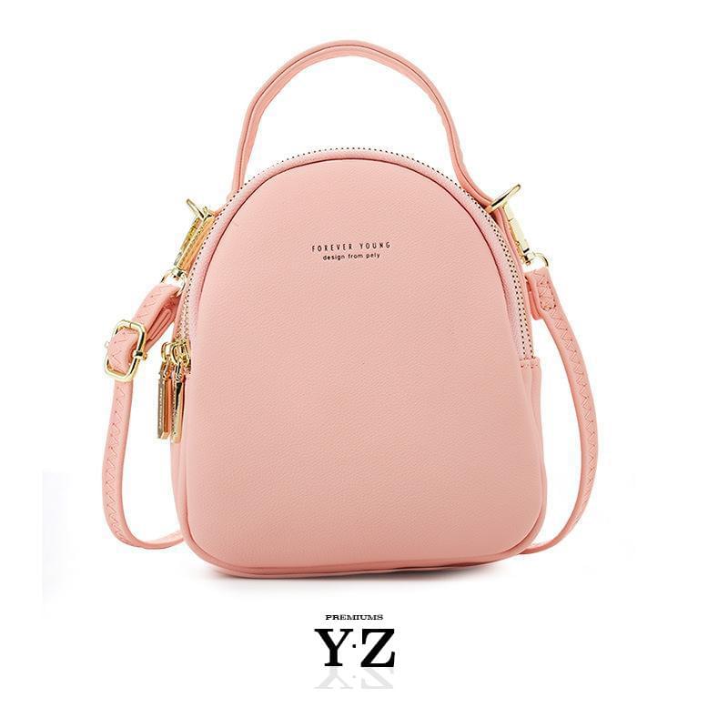 Bold and elegant, the green macaron is one of our favorites. Made with soft, smooth faux-leather, it features a modern, versatile design that styles up any outfit with effortless elegance. The luxurious golden zippers and tags create a stunning accent against the classy green body. Spacious and practical in its design, this cross-body strapped shoulder bag is perfect for carrying your essentials as you head out for an evening filled with fun, excitement, and adventure.