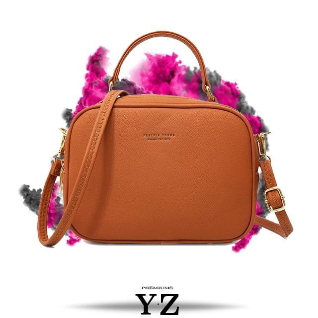 The Signature Handbag has four points in the bottom that ensure a well-balanced bag when not holding the bag. Gold-colored zippers create a shiny style hidden in the details. With a font "Young Forever" with the same color tone as the zippers, gives us the message that stylish Signature handbag is adaptable regardless of age and experience. Inside, we find two equally large pockets in the handbag that offer very good space for everything one would need for an important and charming occasion.